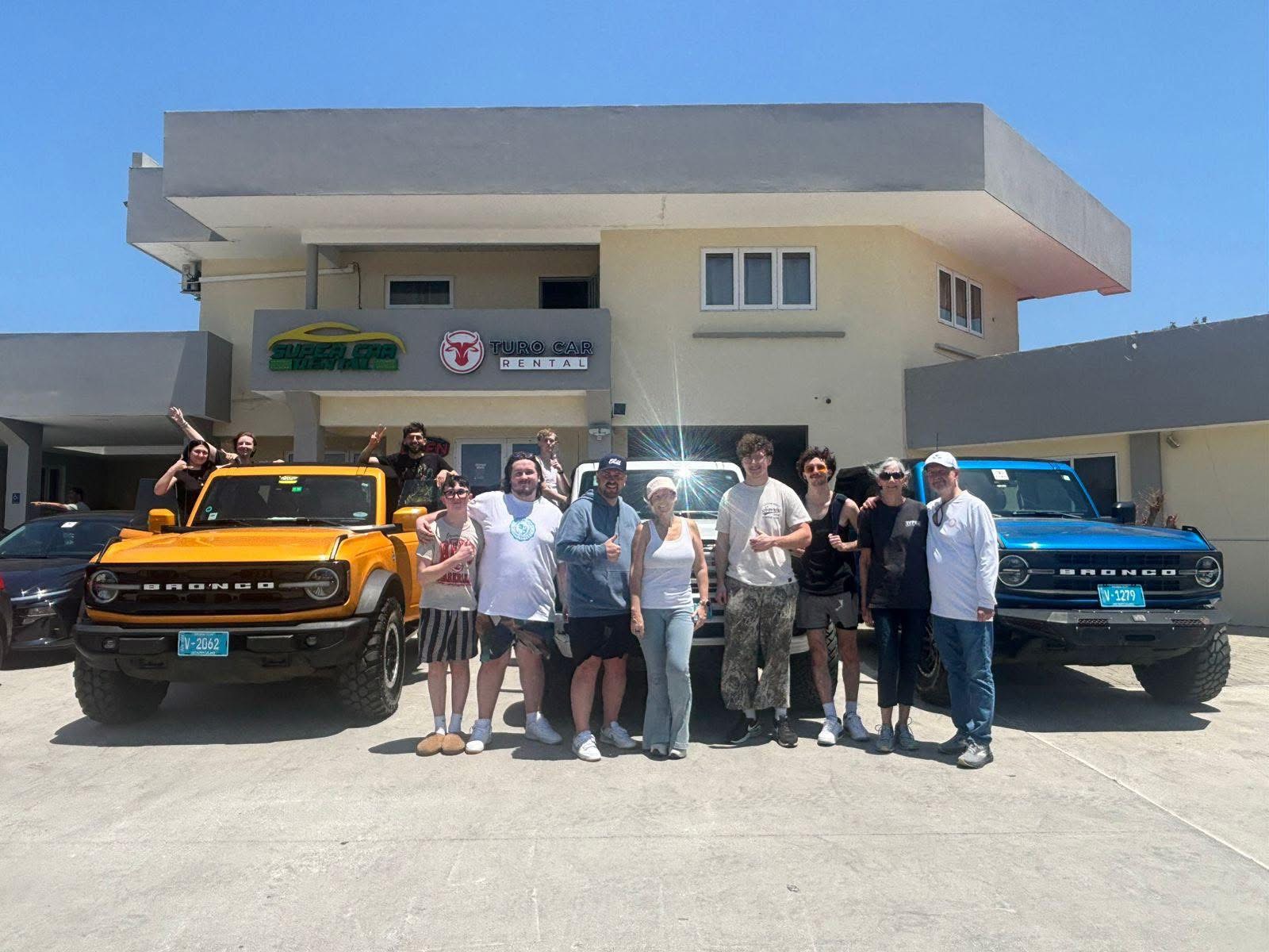 Happy group with their rental car - car rental aruba